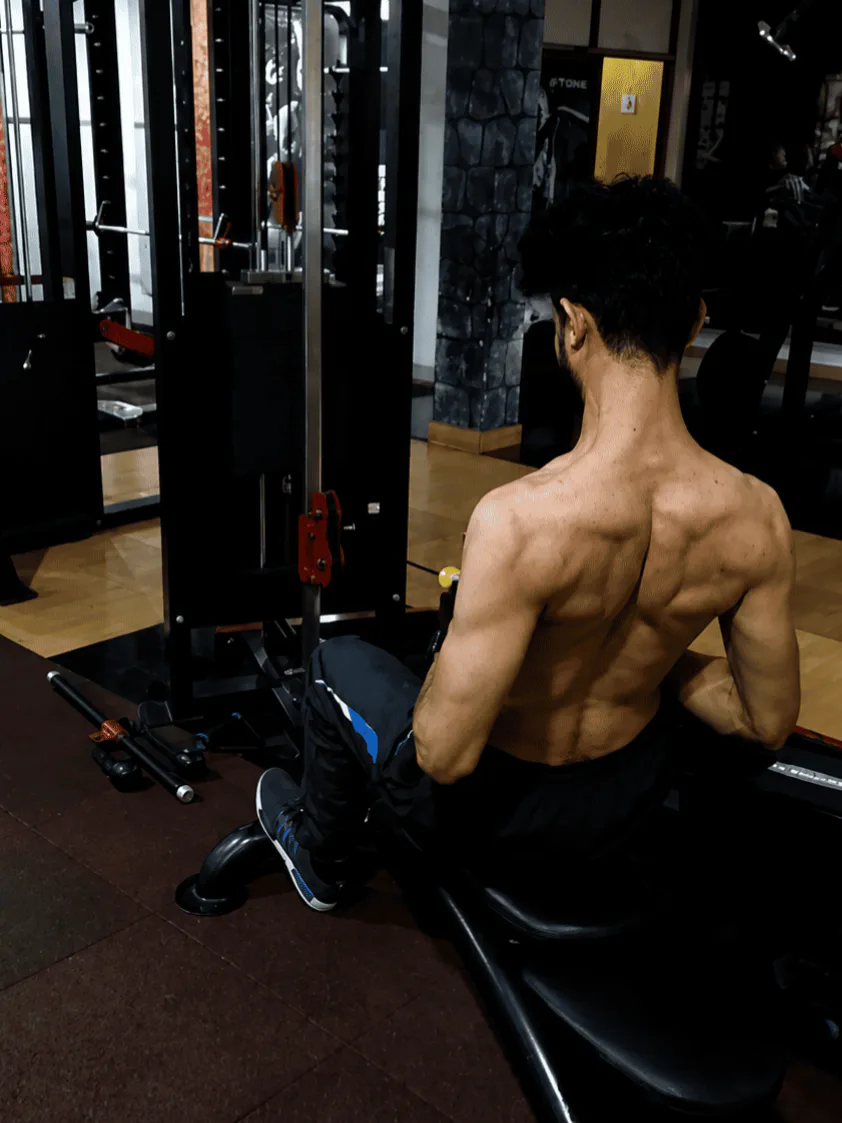 A man doing cable rows, shirtless. Man is Prashant, from Pensieve Labs.
